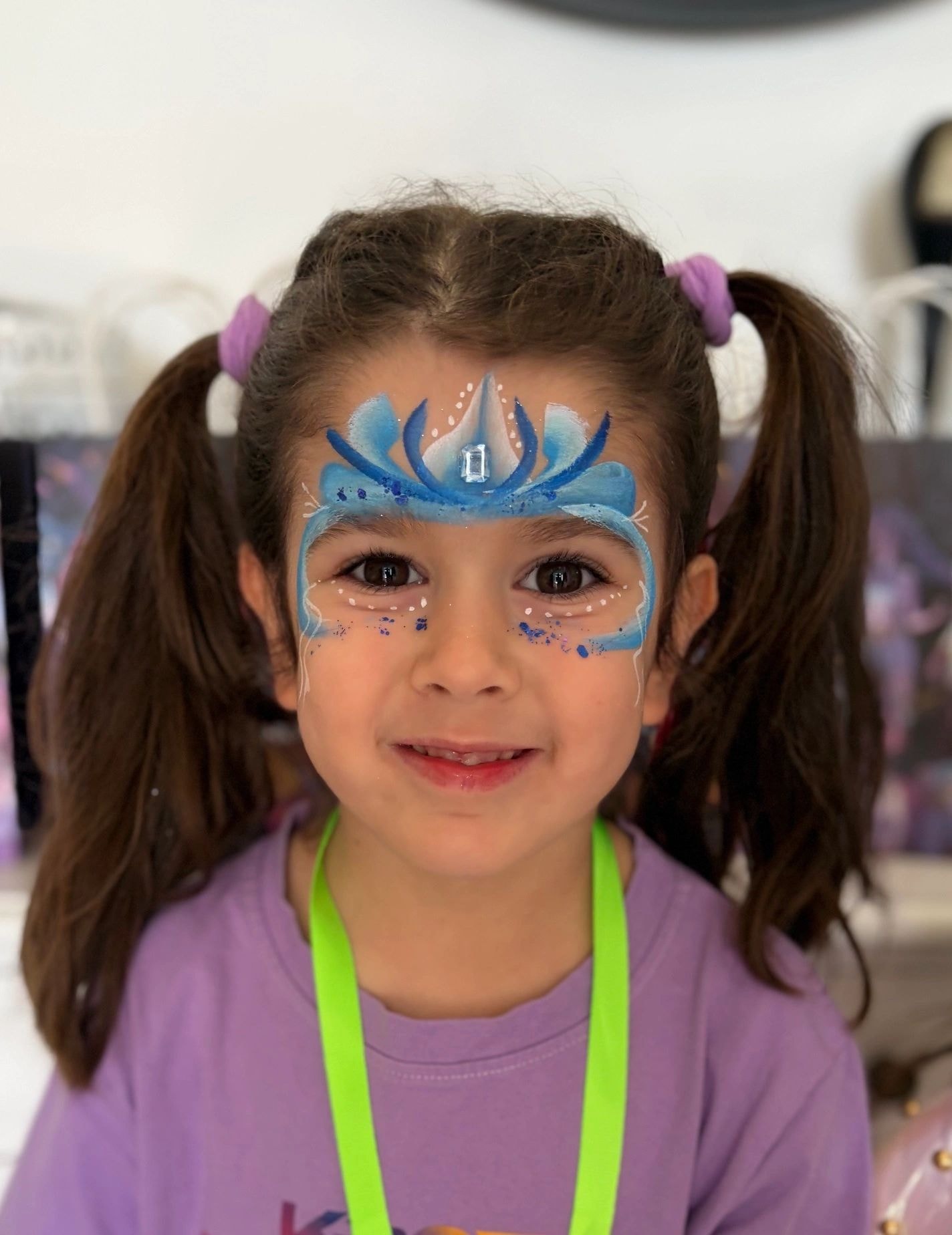 Child with blue lotus forehead face paint