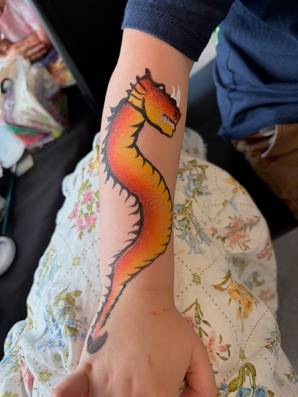 Dragon body art painted on a child's arm
