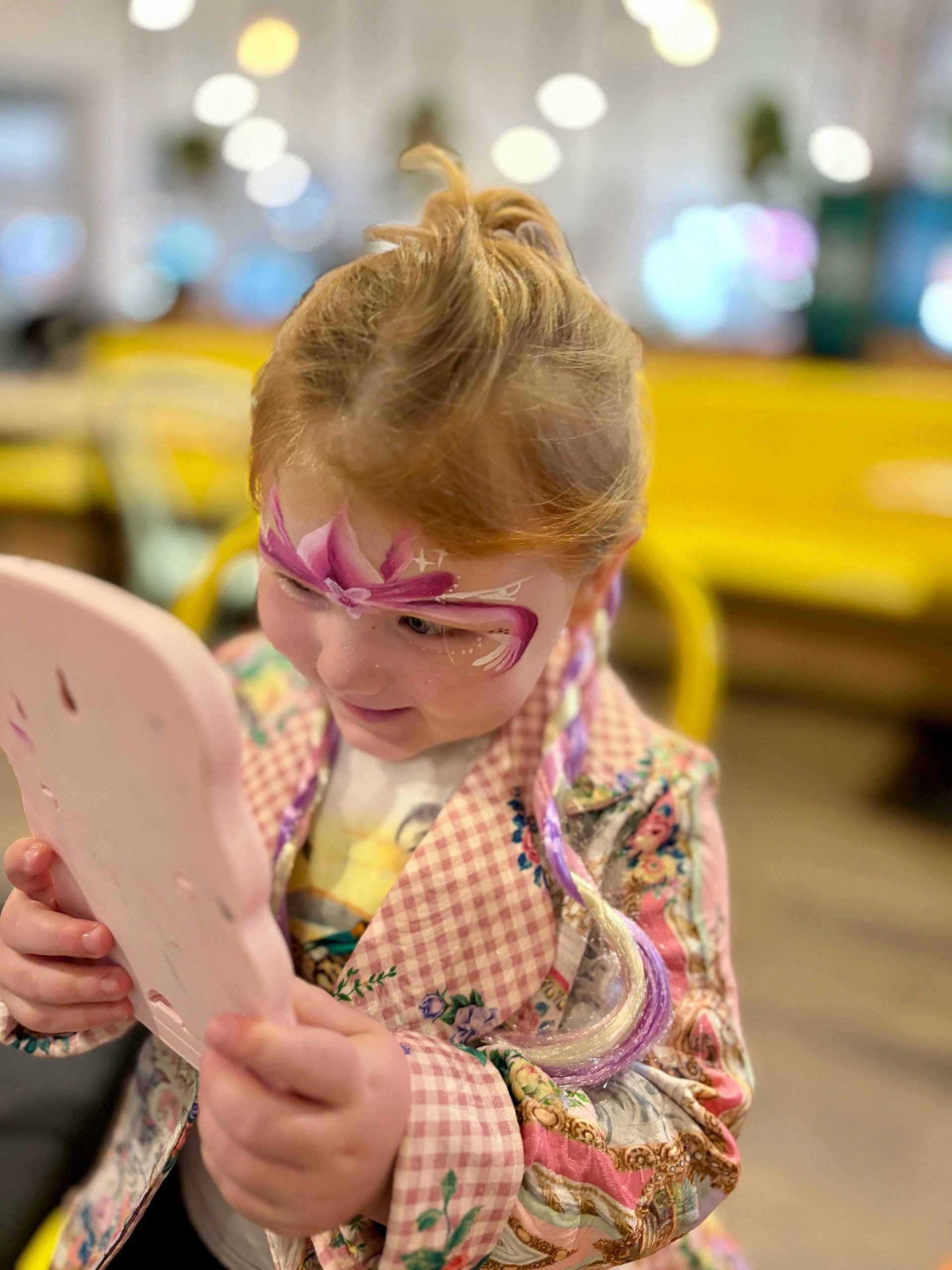 Girl with flower glasses at children's event