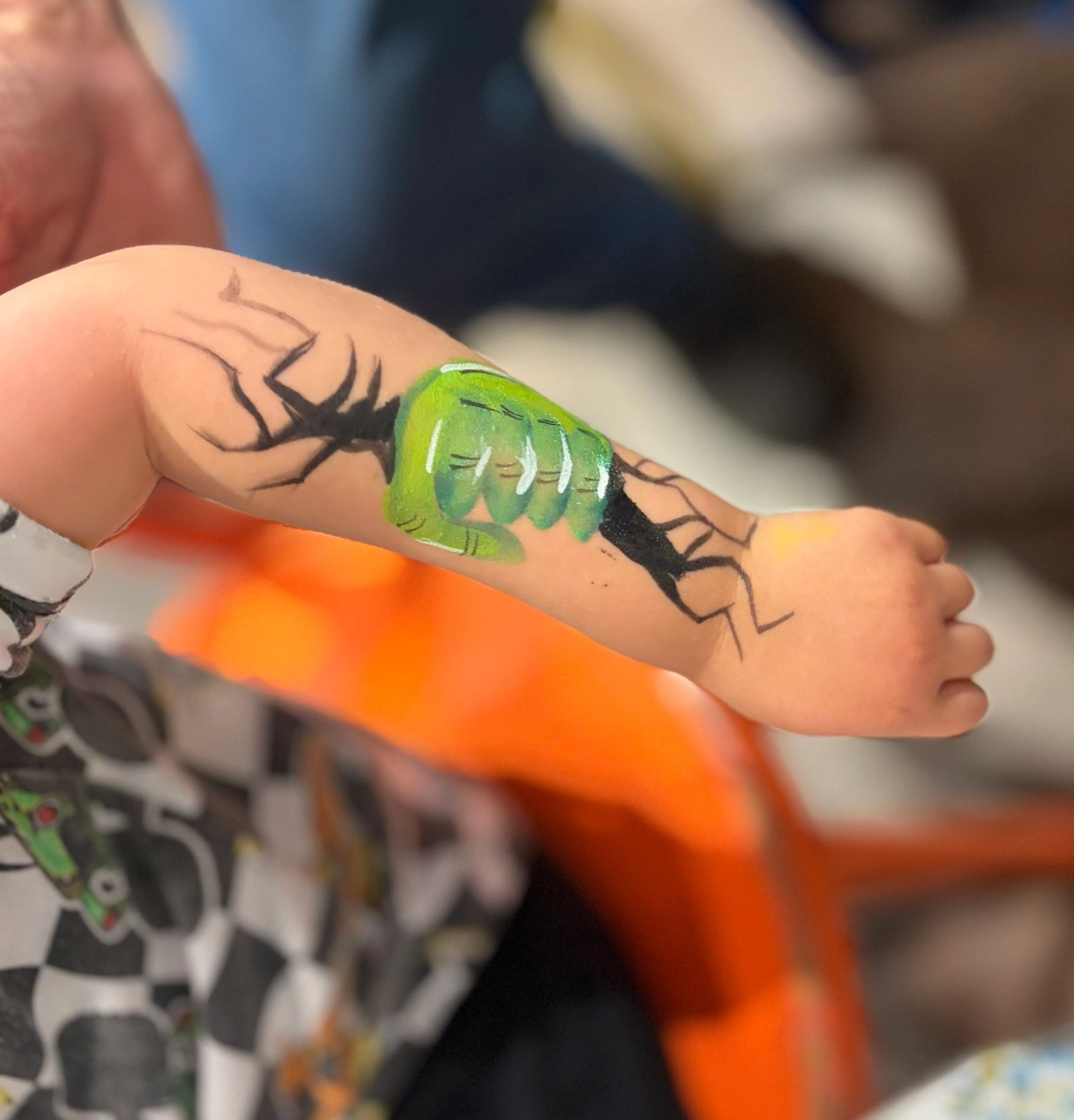 Close-up of leaf design painted on child's hand