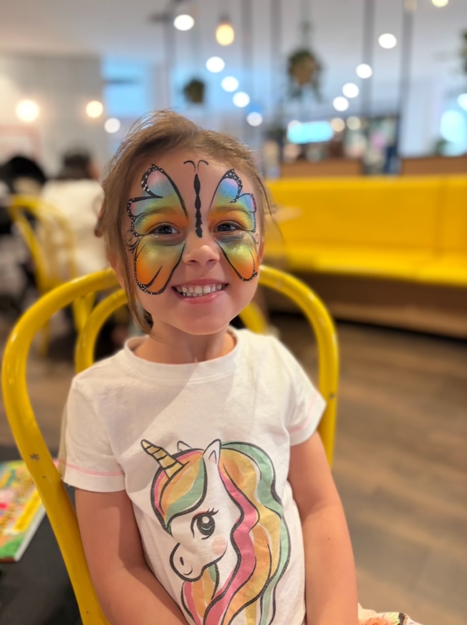 Girl with pink crown face paint and bow headband