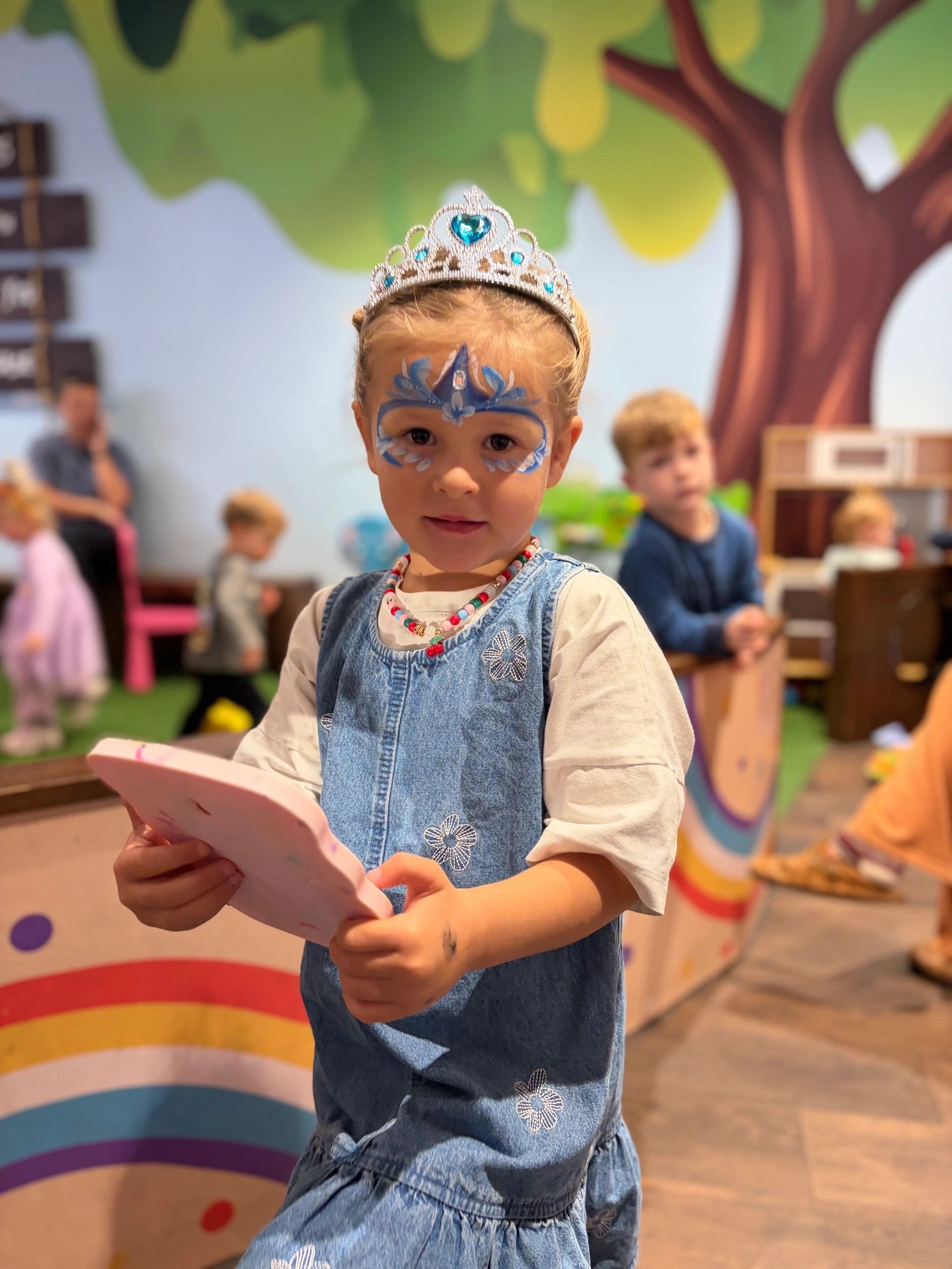 Child dressed as princess with face paint