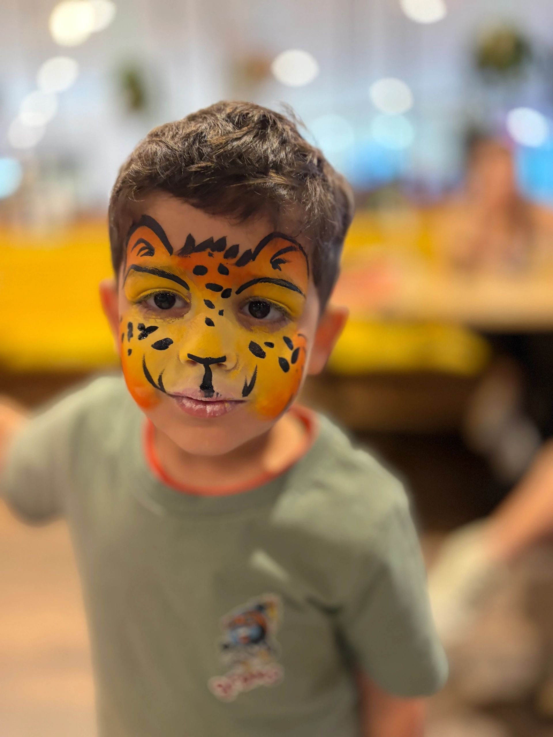 Child with orange tiger face paint